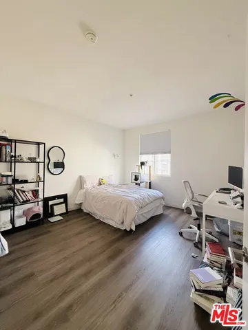 a bedroom with a bed and a desk
