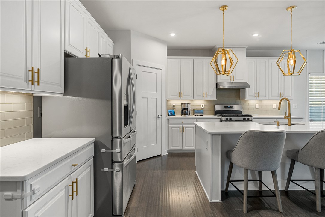 115 Bronson Ridge Anderson, SC 29621 - Photo 13 of 42 This modern culinary space features sleek cabinetry, essential appliances, and a convenient island with seating.