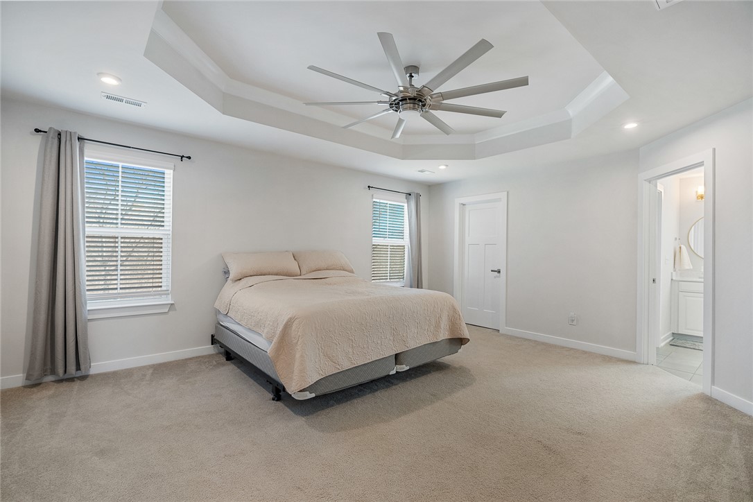 115 Bronson Ridge Anderson, SC 29621 - Photo 26 of 42 Bright and airy sleeping area features a high tray ceiling and soft carpeted flooring.