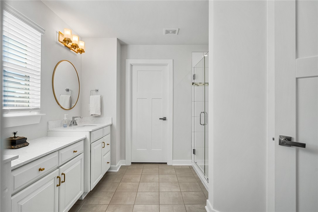 115 Bronson Ridge Anderson, SC 29621 - Photo 29 of 42 This bright bathroom features a spacious vanity with elegant finishes and a glass-enclosed shower.