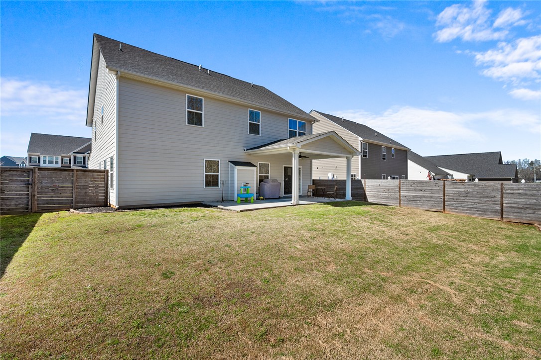 115 Bronson Ridge Anderson, SC 29621 - Photo 42 of 42 This spacious backyard provides ample room for outdoor activities and relaxation, featuring a covered patio.