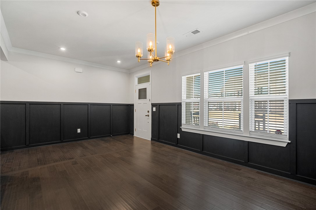 115 Bronson Ridge Anderson, SC 29621 - Photo 6 of 42 This versatile space features rich hardwood flooring and a stylish board and batten accent wall.