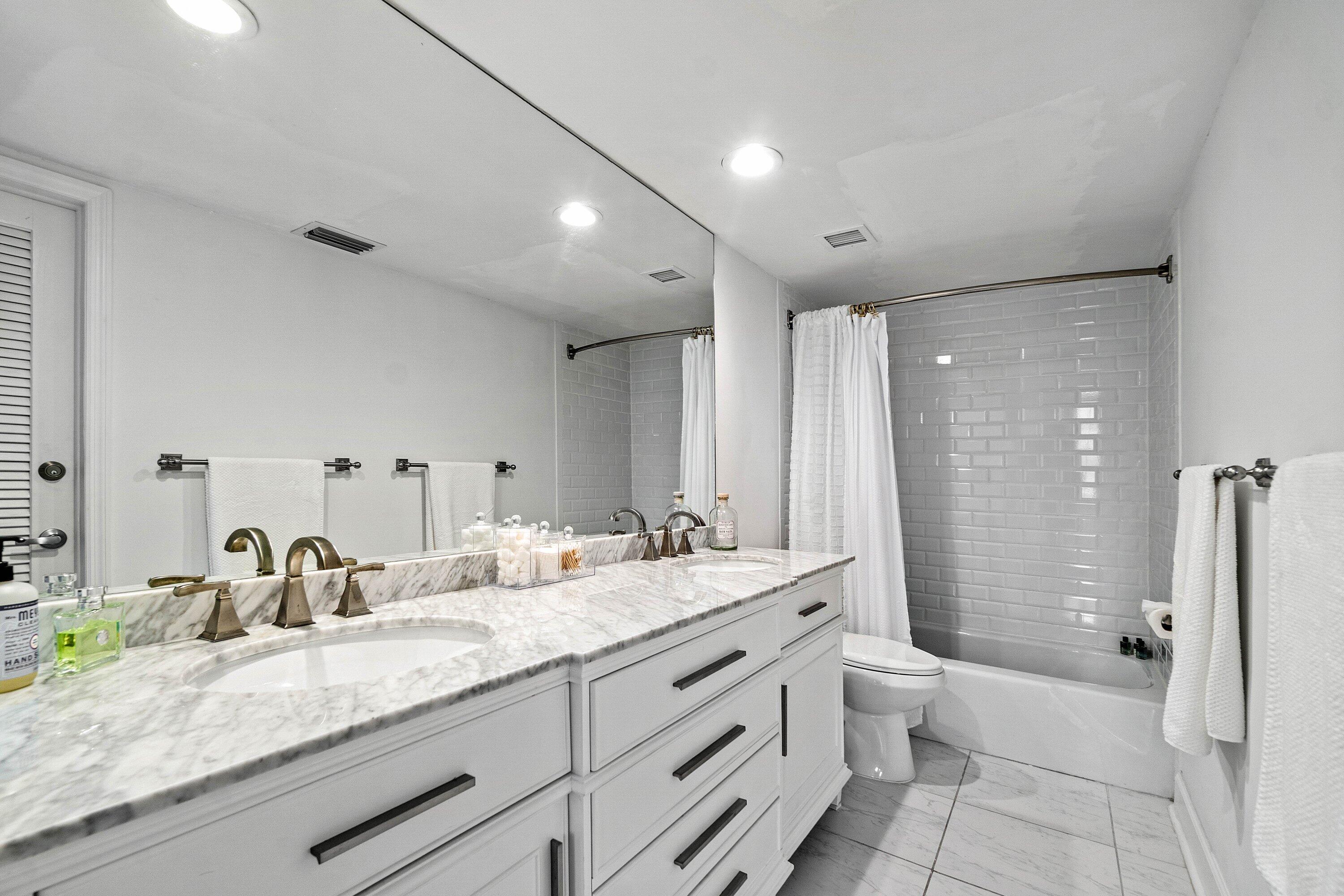 3800 Washington Road, Unit 904 West Palm Beach, FL 33405 - Photo 13 of 27 a bathroom with a granite countertop sink mirror and a toilet