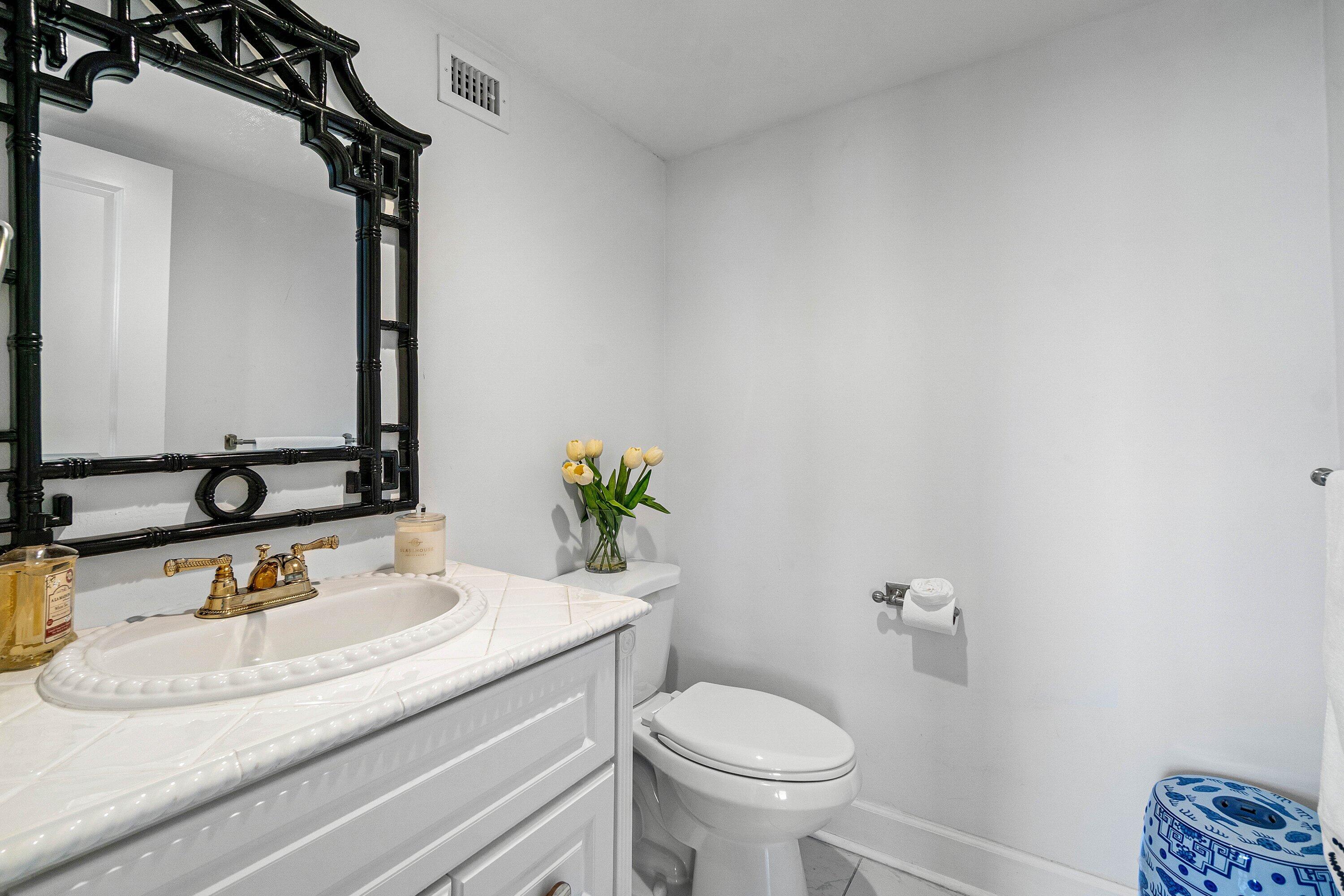 3800 Washington Road, Unit 904 West Palm Beach, FL 33405 - Photo 14 of 27 a bathroom with a granite countertop sink and a mirror