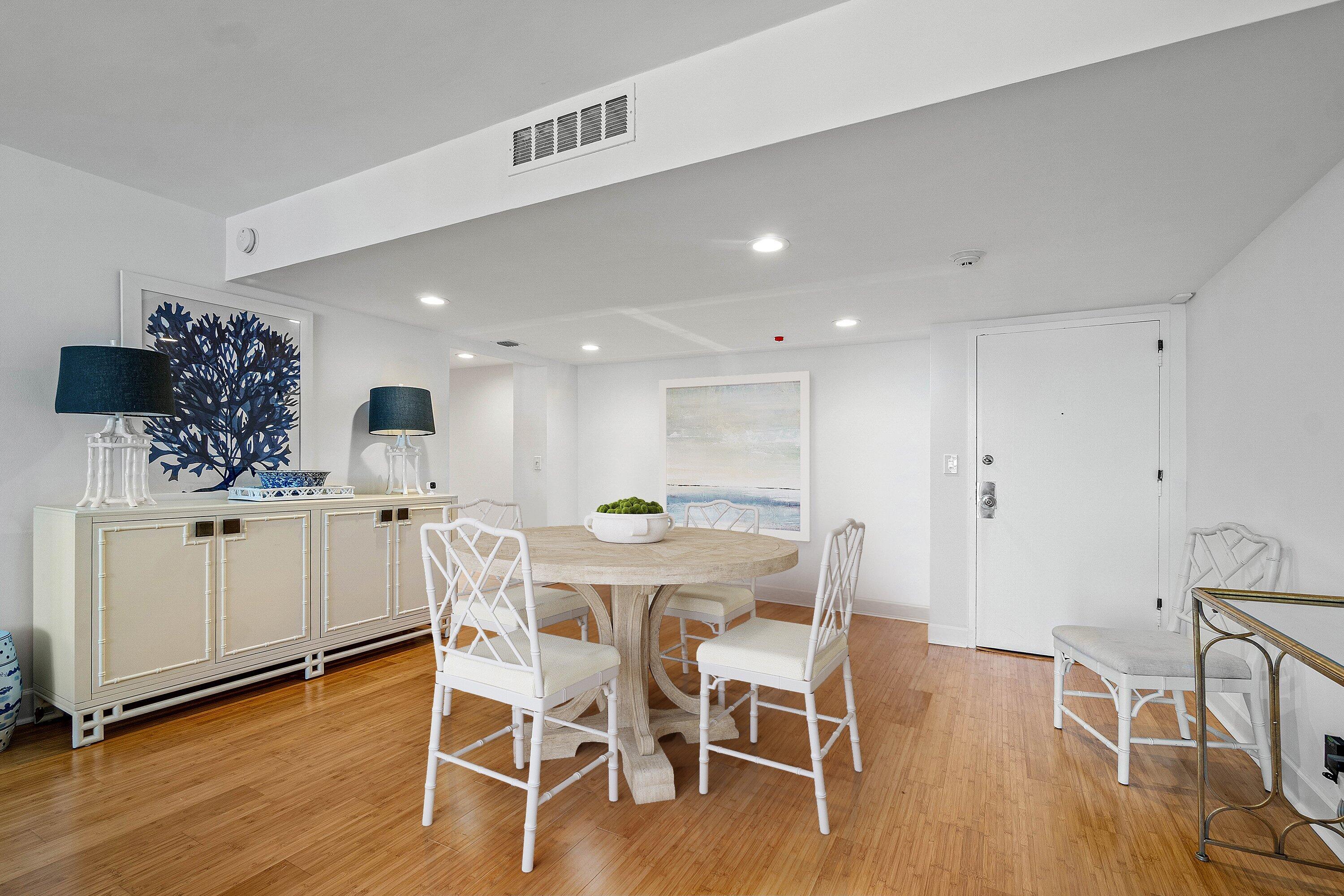 3800 Washington Road, Unit 904 West Palm Beach, FL 33405 - Photo 6 of 27 a view of a dining room with furniture and wooden floor