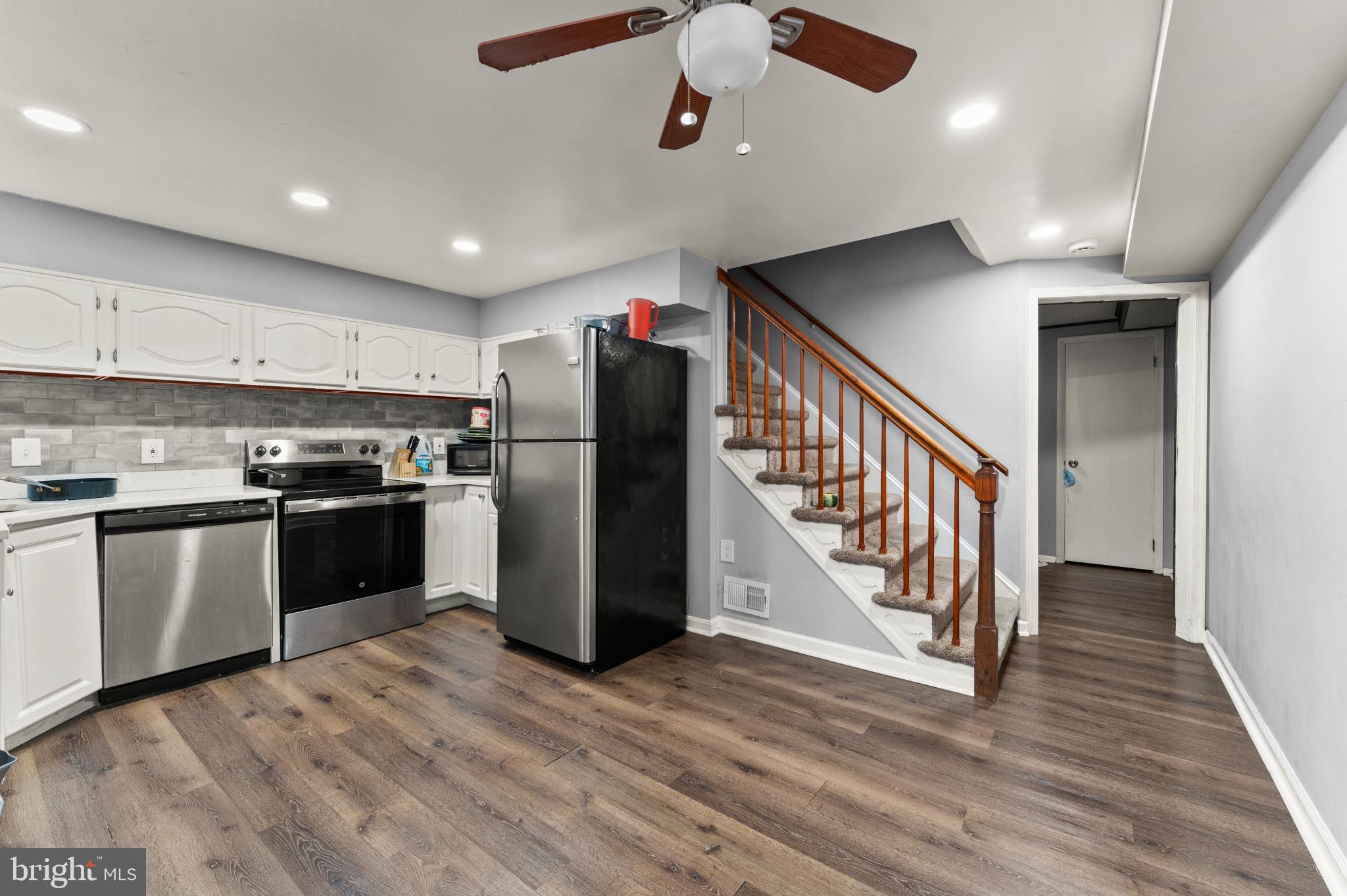 8146 Gray Haven Road Dundalk, MD 21222 - Photo 9 of 18 a kitchen with stainless steel appliances granite countertop a refrigerator a stove top oven a sink and dishwasher