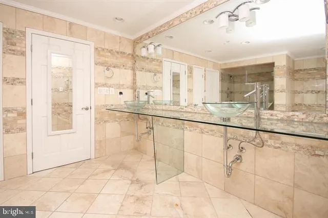 a bathroom with a granite countertop sink a large mirror and a shower