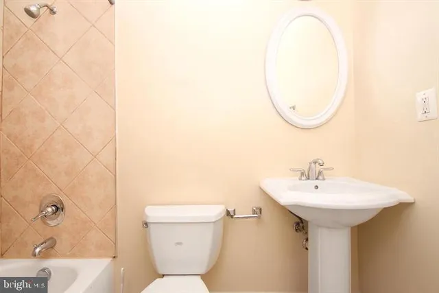 a bathroom with a sink a mirror and a toilet