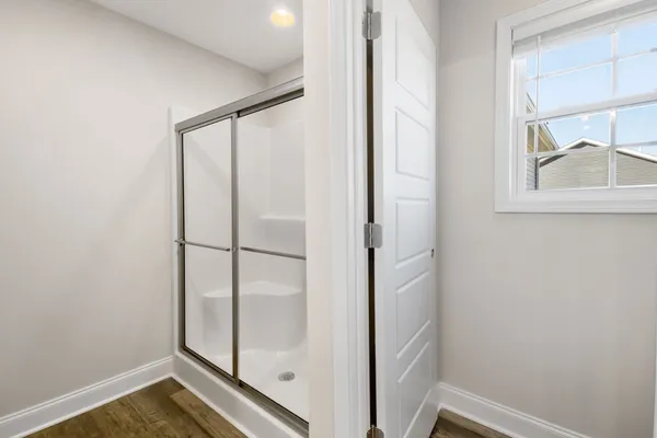 a bathroom with a glass shower door