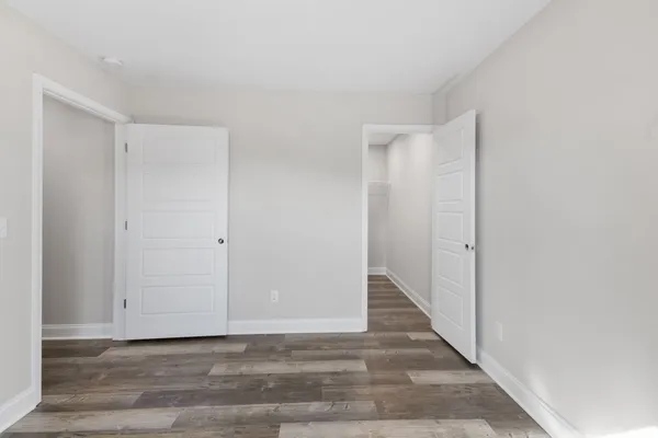 a view of hallway with wooden floor