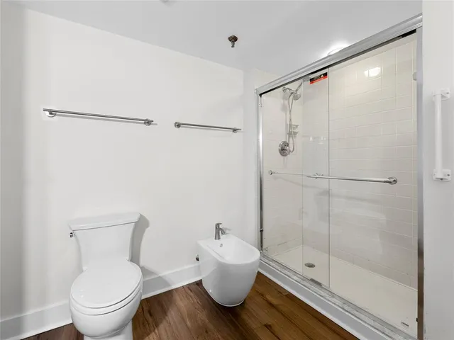 a white toilet sitting next to a bathroom