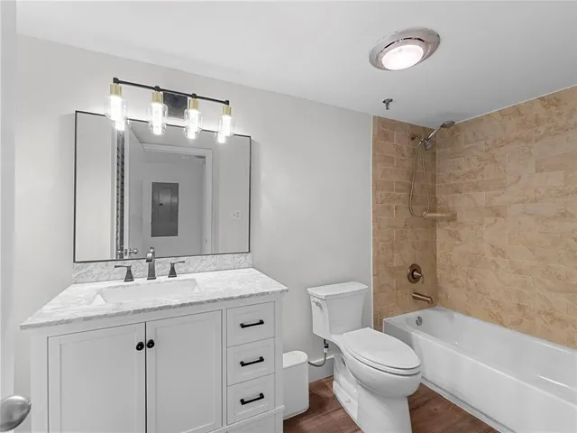 a bathroom with a sink toilet vanity and tub