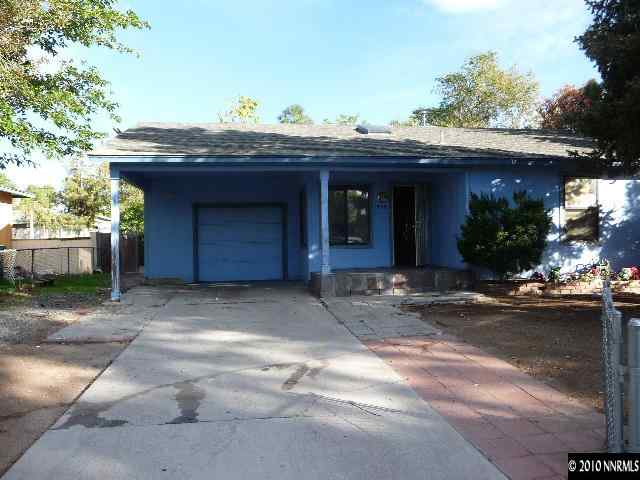 1555 Castle Way Reno, NV 89512 - Photo 1 of 8 a view of a house with a garage and plants