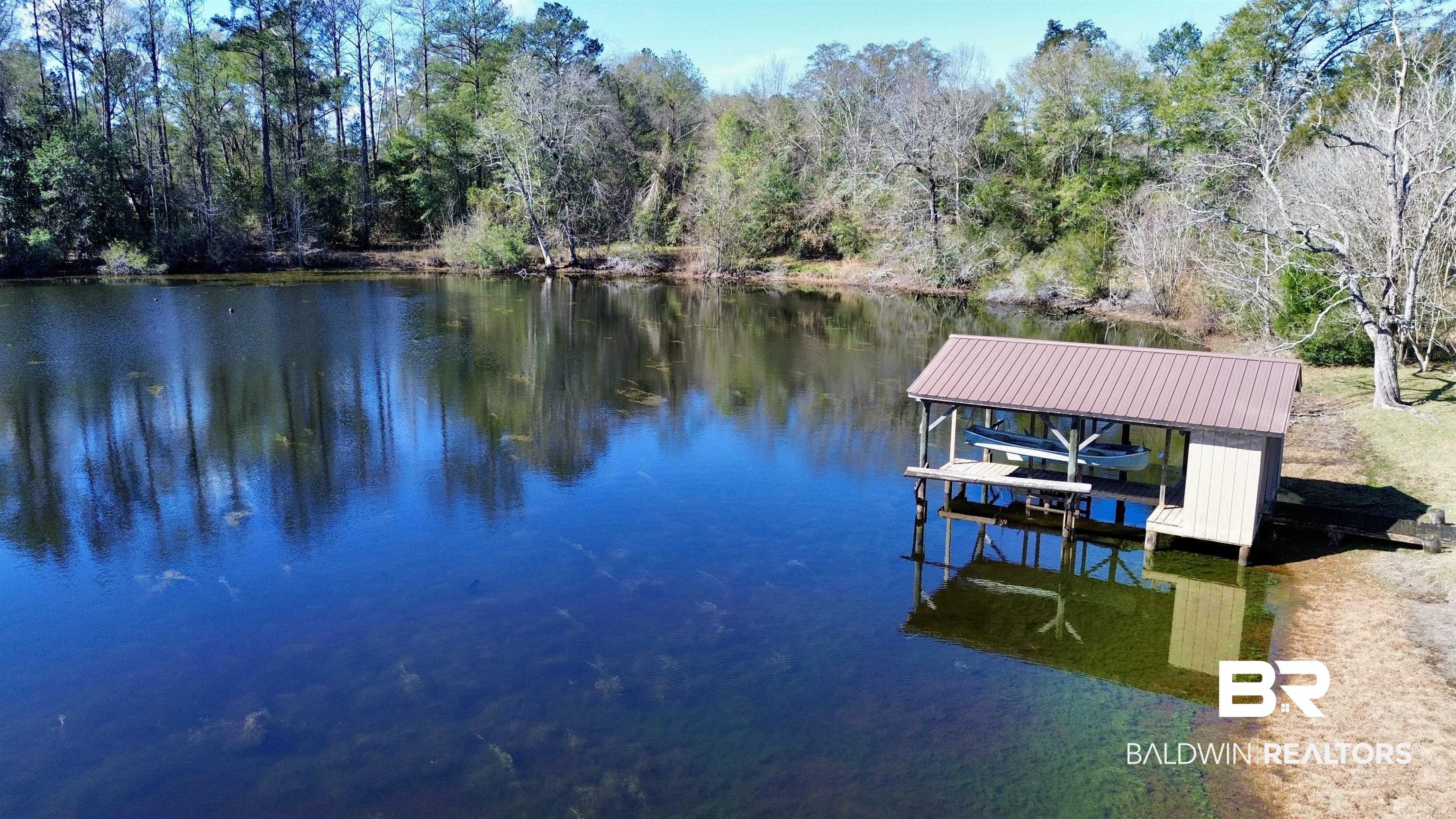 44 Ridge Road Castleberry, AL 36432 - Photo 30 of 33 Dock with boat lift and a water view