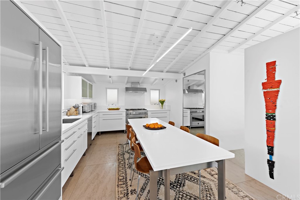 239 Fairview Street Laguna Beach, CA 92651 - Photo 16 of 67 a kitchen that has a lot of white cabinets and stainless steel appliances