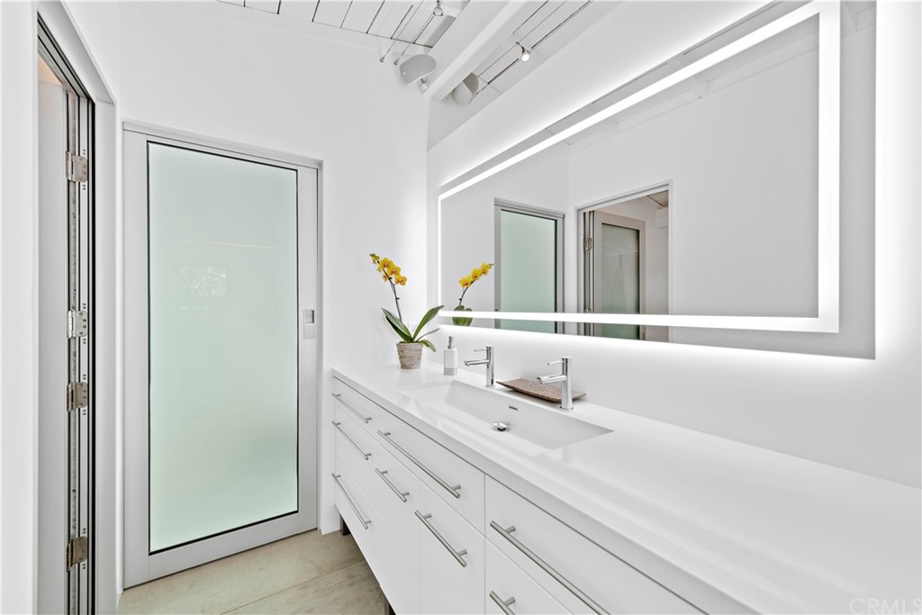 239 Fairview Street Laguna Beach, CA 92651 - Photo 29 of 67 a bathroom with a double vanity sink mirror and next to a window