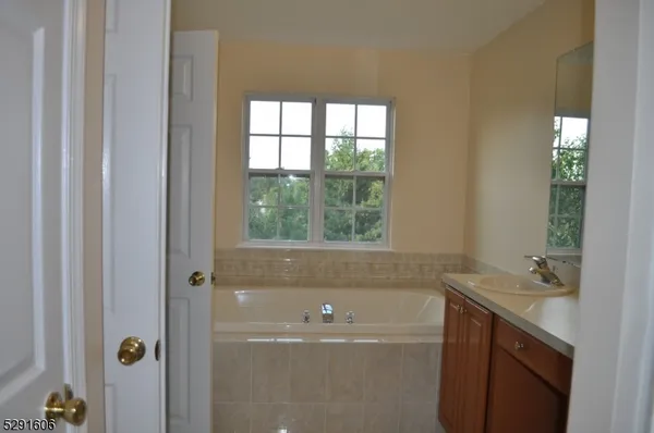 a bathroom with a bathtub and sink