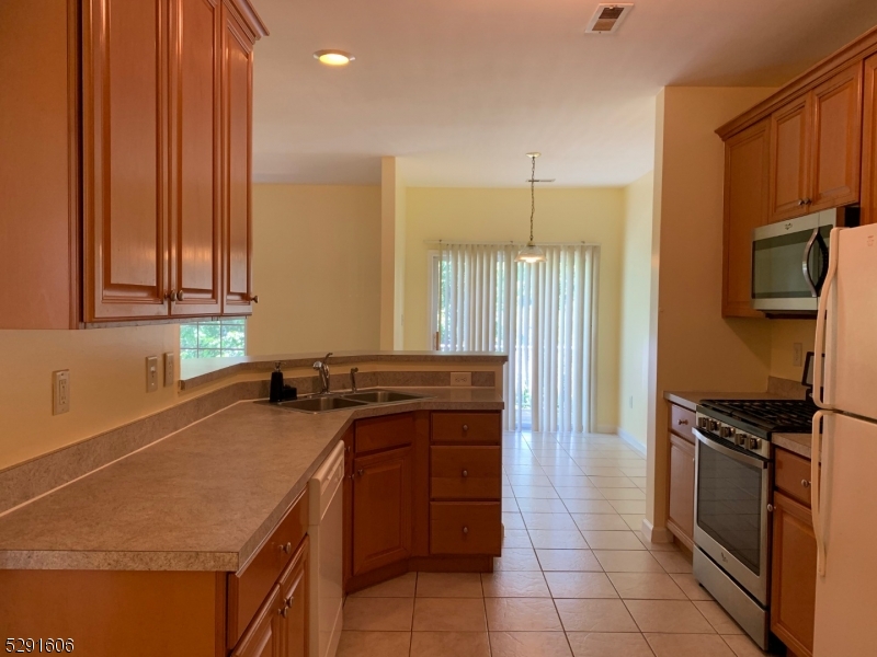 51 Truman Avenue Princeton, NJ 08540 - Photo 2 of 14 a kitchen with a sink a stove cabinets and stainless steel appliances