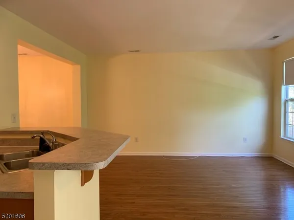 a view of kitchen and an empty room
