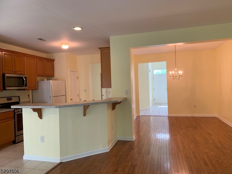 51 Truman Avenue Princeton, NJ 08540 - Photo 6 of 14 a view of a kitchen with stainless steel appliances cabinets and a wooden floor