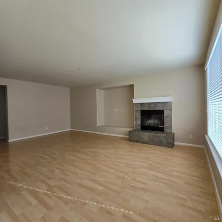 a view of empty room with a fireplace