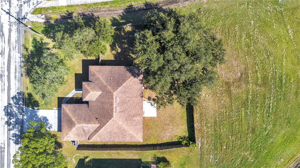 887 Adour Drive Kissimmee, FL 34759 - Photo 12 of 16 an aerial view of residential house with outdoor space and trees all around