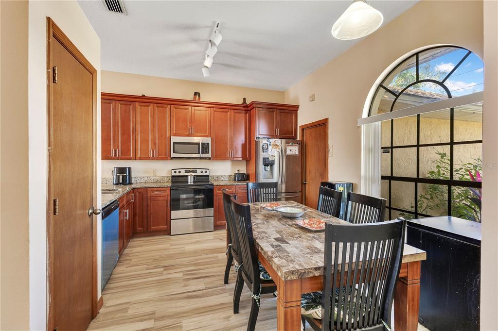887 Adour Drive Kissimmee, FL 34759 - Photo 4 of 16 a view of a dining room with furniture window and wooden floor