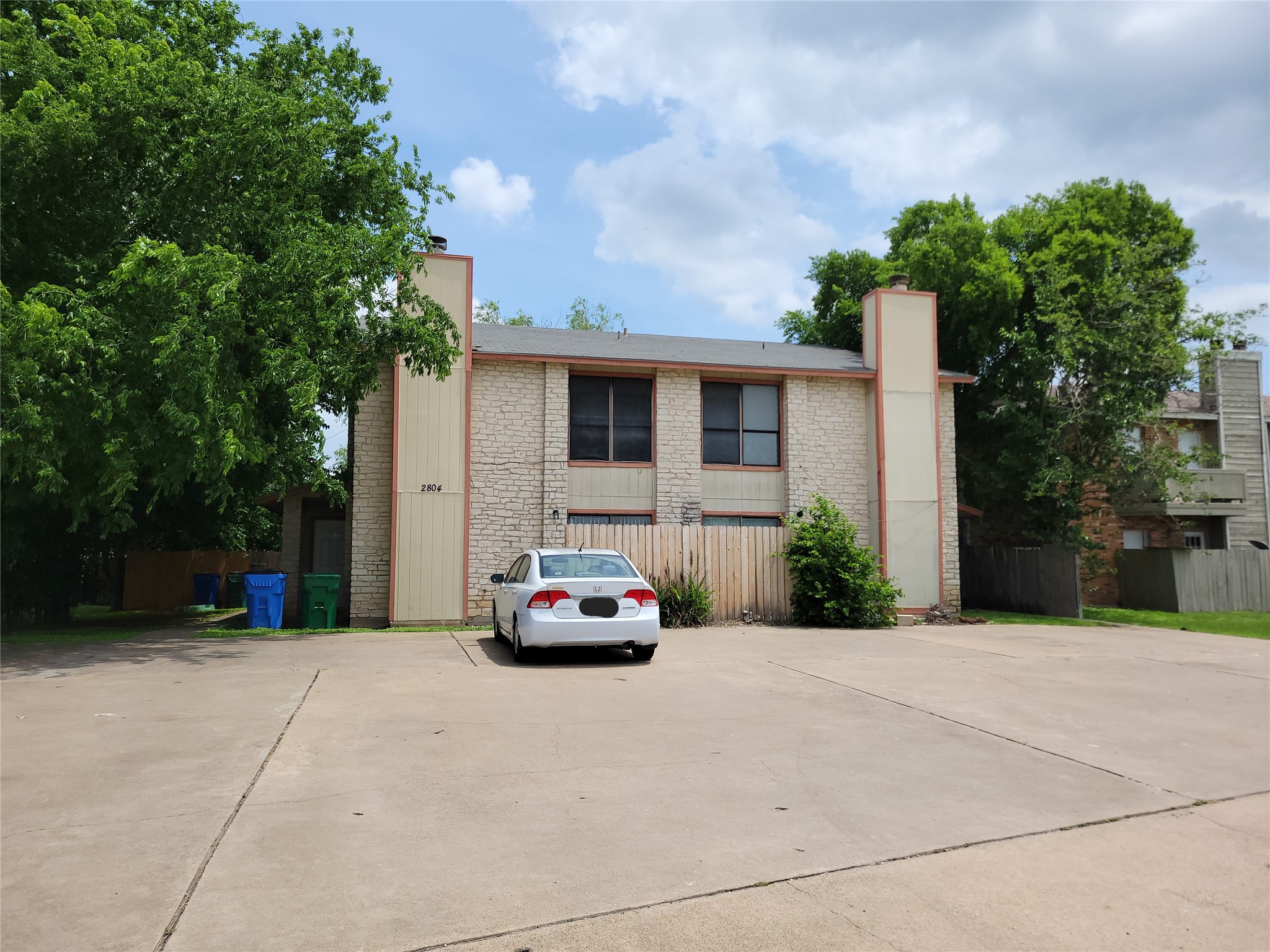 2804 Bull Run, Unit B Taylor, TX 76574 - Photo 1 of 9 a car parked in front of white house
