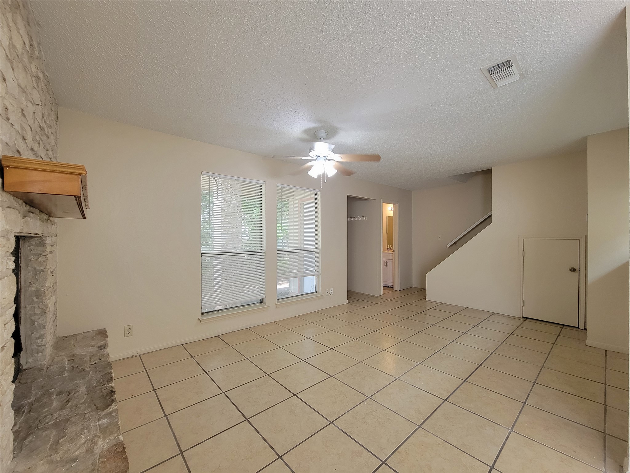 2804 Bull Run, Unit B Taylor, TX 76574 - Photo 4 of 9 a view of a livingroom with a chandelier fan and windows