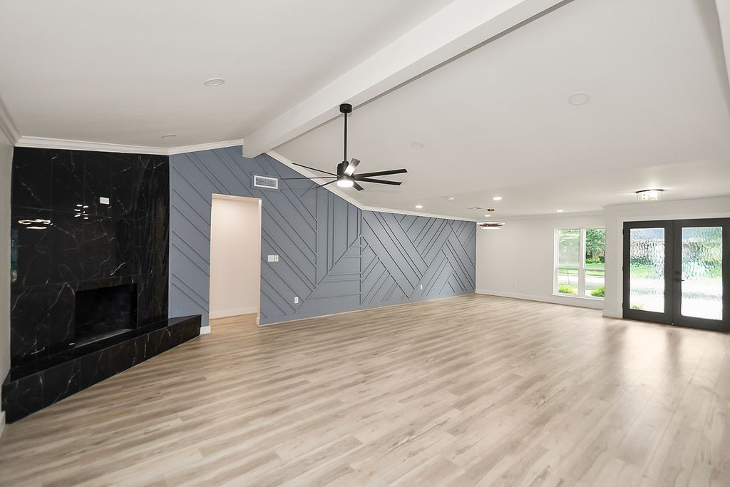 6106 Rutherglenn Drive Houston, TX 77096 - Photo 4 of 41 Bright open-concept living area featuring vaulted ceilings, engineered hardwood flooring, and modern finishes.