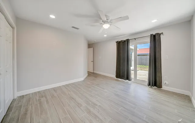 wooden floor in an empty room with a window
