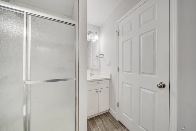 a bathroom with a glass shower door