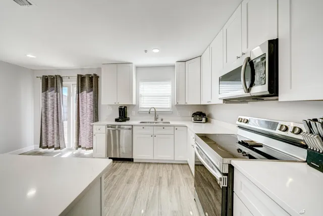 a kitchen with a sink stove and cabinets