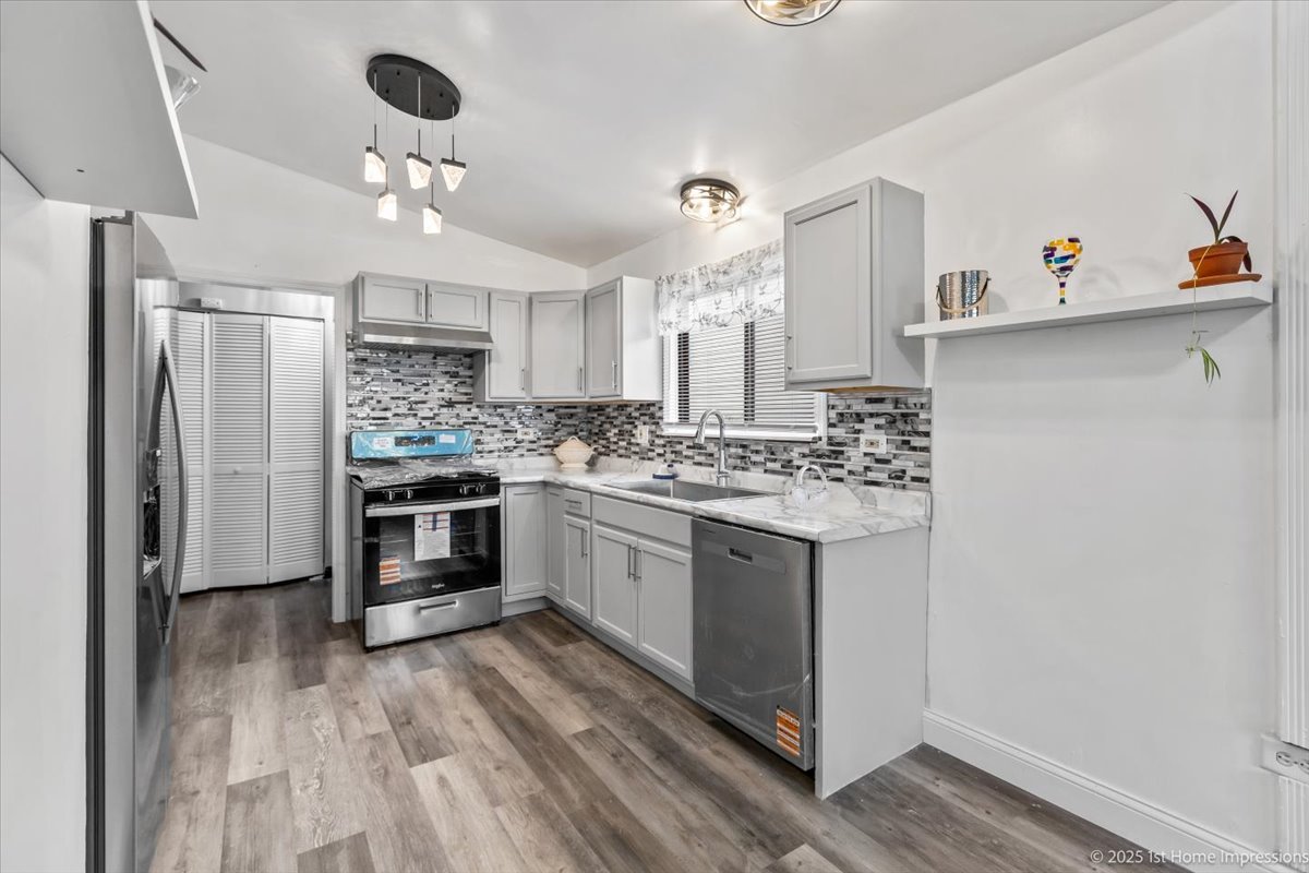 18109 Idlewild Drive Country Club Hills, IL 60478 - Photo 8 of 21 a kitchen with stainless steel appliances a refrigerator and a stove top oven