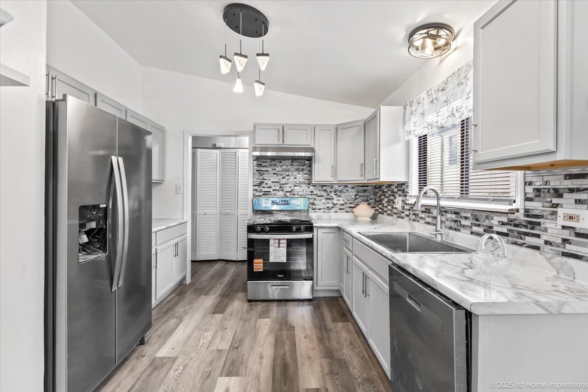18109 Idlewild Drive Country Club Hills, IL 60478 - Photo 9 of 21 a kitchen with a sink stainless steel appliances a counter top space cabinets and stainless steel appliances