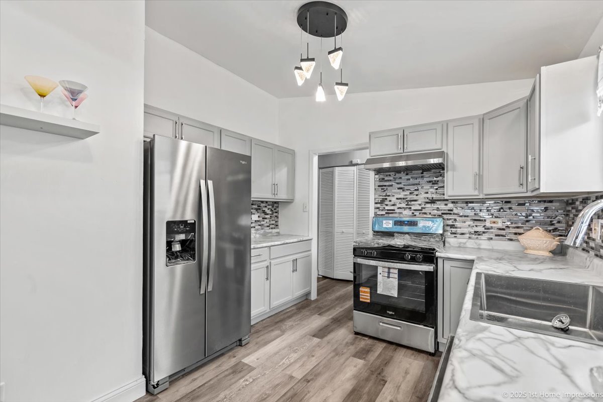 18109 Idlewild Drive Country Club Hills, IL 60478 - Photo 10 of 21 a kitchen with stainless steel appliances a stove a refrigerator and cabinets