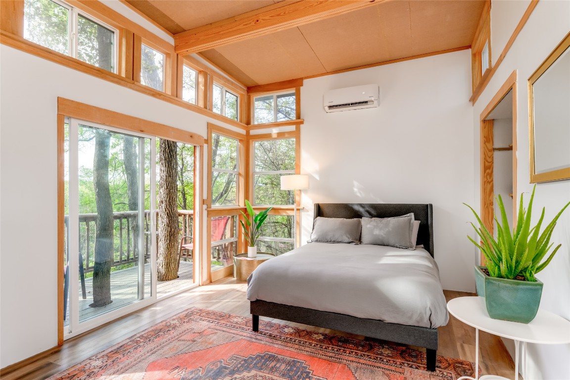 a bedroom with a large bed and a large window