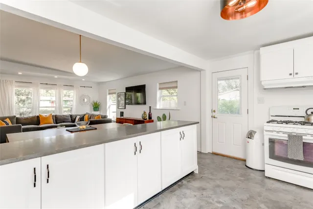 a kitchen with counter top space a sink cabinets and appliances