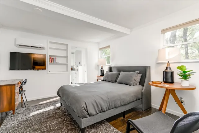 a bedroom with a bed and flat screen tv
