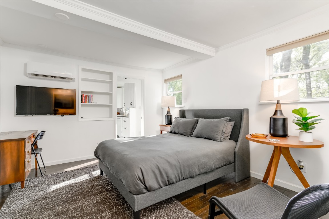 5323 Downs Drive Austin, TX 78721 - Photo 12 of 28 a bedroom with a bed and flat screen tv