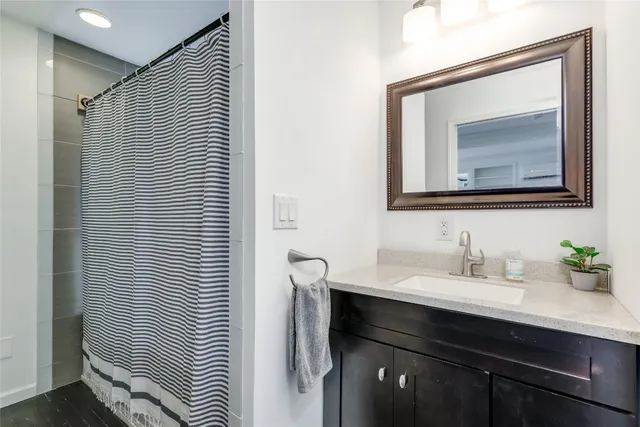 a bathroom with a sink vanity and a mirror