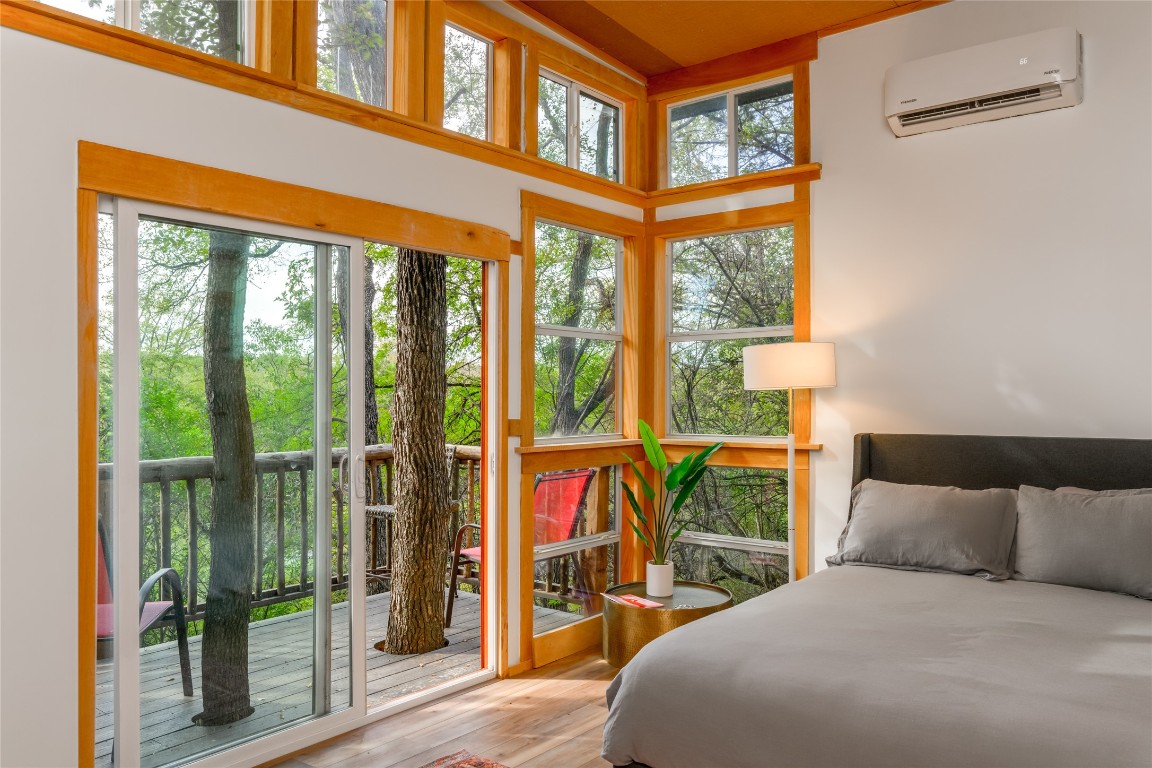 5323 Downs Drive Austin, TX 78721 - Photo 17 of 28 a bedroom with a bed and a large window with outer view