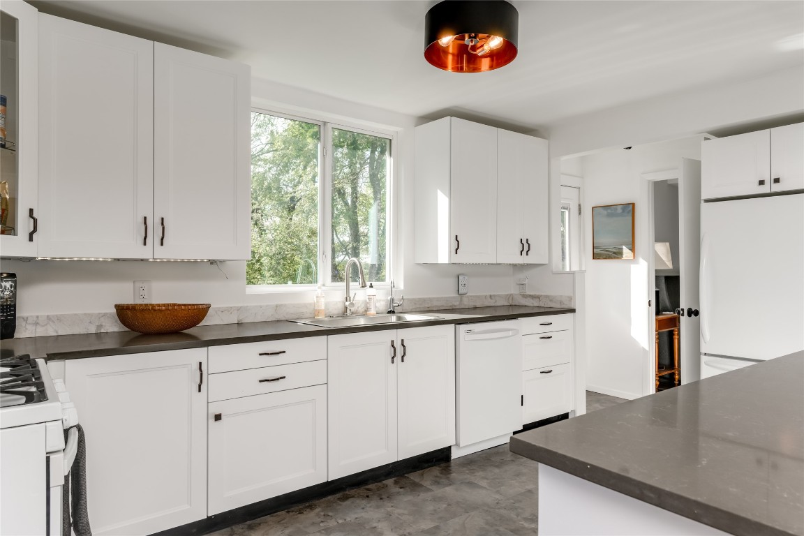 5323 Downs Drive Austin, TX 78721 - Photo 10 of 28 a kitchen with granite countertop white cabinets and a sink