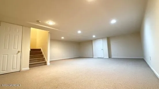an empty room with a staircase and white walls