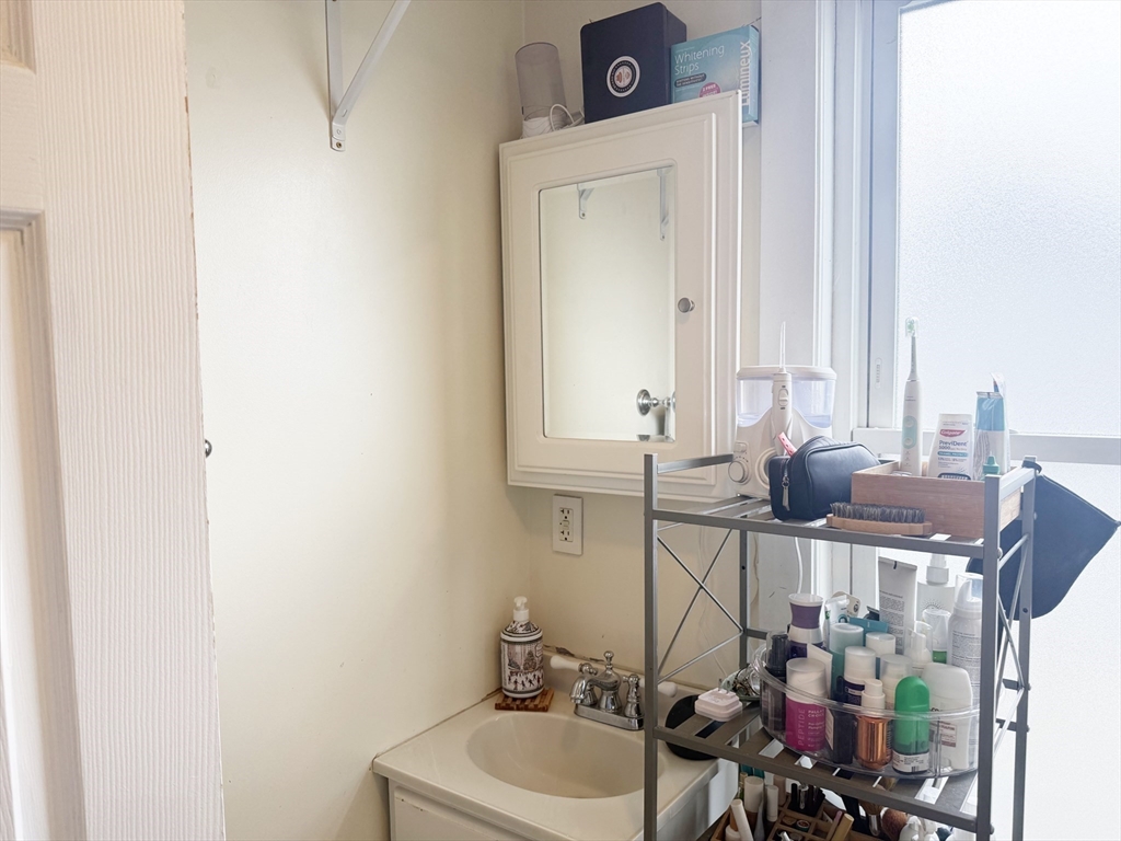 37 Prospect St Avenue, Unit 2 Waltham, MA 02453 - Photo 12 of 14 a bathroom with a sink and a mirror