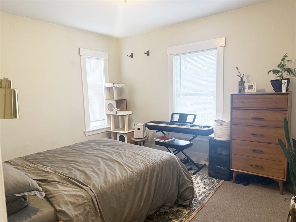 37 Prospect St Avenue, Unit 2 Waltham, MA 02453 - Photo 3 of 14 a bedroom with a bed and a dresser