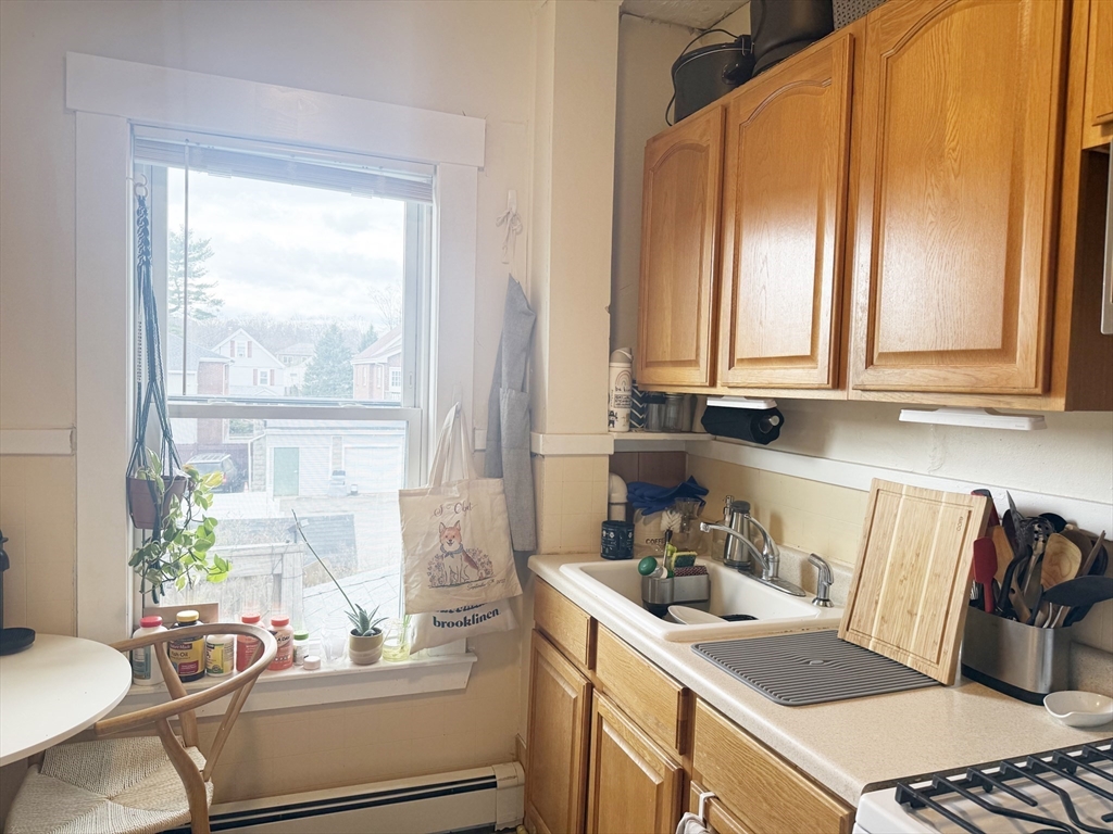 37 Prospect St Avenue, Unit 2 Waltham, MA 02453 - Photo 9 of 14 a room with a window wooden floor and a table chair