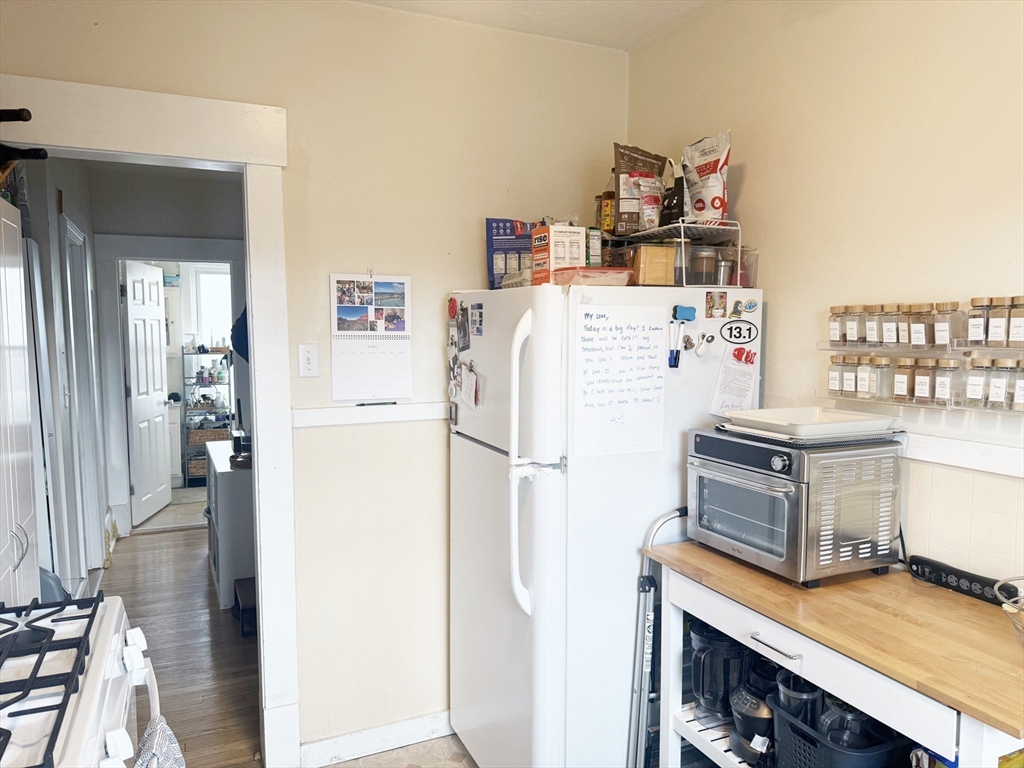37 Prospect St Avenue, Unit 2 Waltham, MA 02453 - Photo 10 of 14 a kitchen with a refrigerator a stove and a cabinets