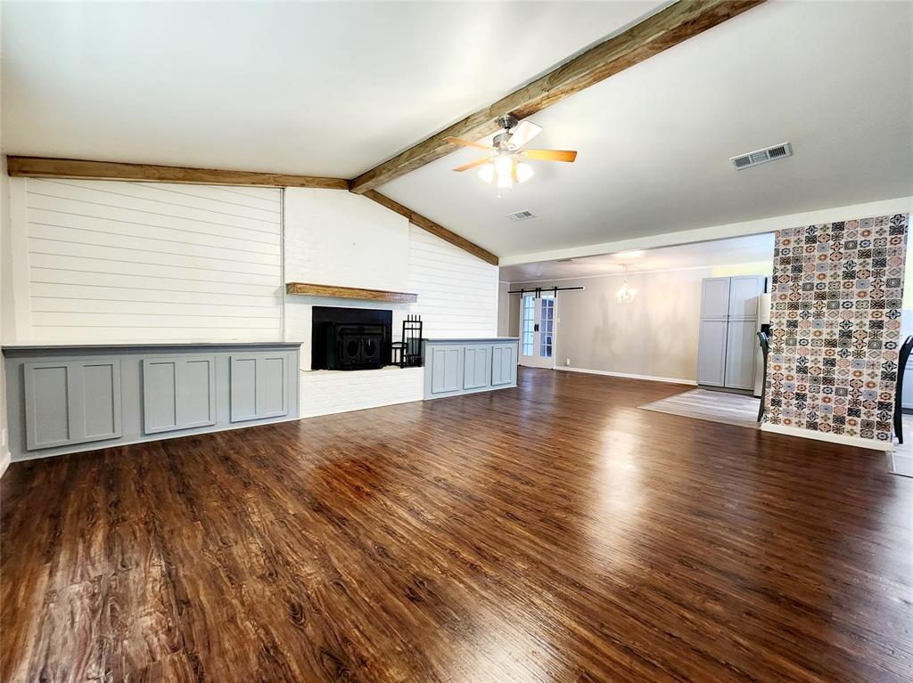 3514 Buchanan Loop Road Texarkana, TX 75501 - Photo 2 of 40 an empty room with wooden floor fireplace and windows