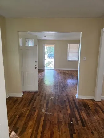 a view of a room with wooden floor and cabinet
